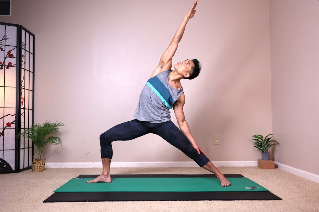 Mike Ling in extended side angle pose on a mat